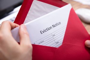 Person Holding Eviction Notice In Envelope