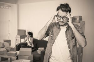 Man looking stressed with his head in his hands