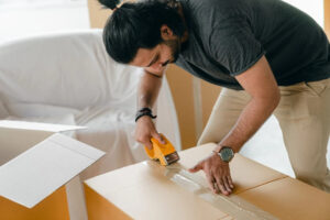 Sealing a box with a tape gun before transport