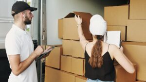 Landlord speaking with a tenant beside packed boxes