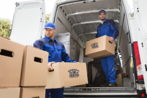 Movers loading boxes into a van