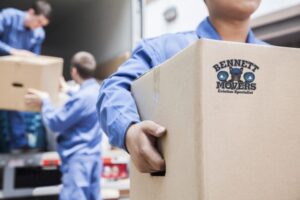 Professional mover carrying a labelled box